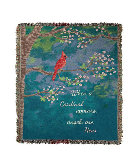 the throw blanket showing a red cardinal on a blue scenic background and the tpoduct title written on the blanket