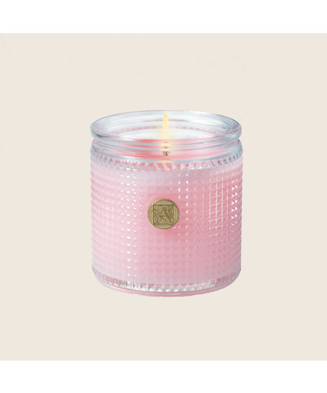 colored aromatic candle on a neutral white background